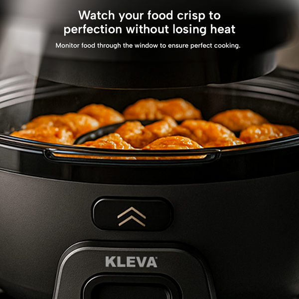 Close-up of food crisping inside Kleva air fryer with viewing window.