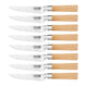 Four KlevaCut® Master Series steak knives by Kleva Range, featuring precision-serrated blades and bamboo handles, are arranged vertically against a white background. The blades display the brand name.