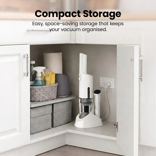 Cordless vacuum cleaner stored upright in a kitchen cabinet using a compact charging base