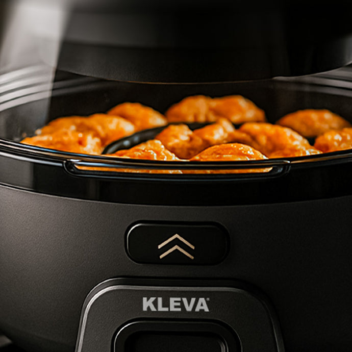 Chicken wings browning evenly inside the Spin Crisp stainless steel pot.