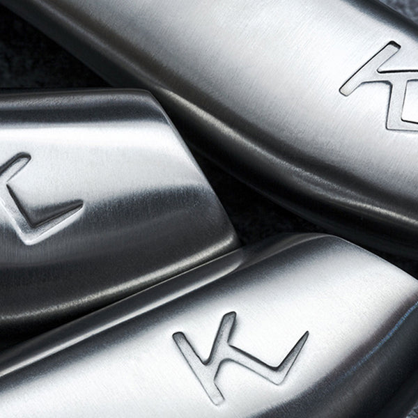 Close-up of three Kleva Range knives from the KlevaCut® LIMITED EDITION 4 Piece Premium Knife Set, featuring smooth stainless steel with a stylized K logo. Lighting accentuates the brushed Japanese Vamolcrium steel and premium craftsmanship.