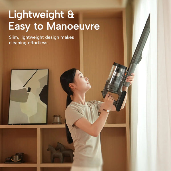 Lightweight cordless stick vacuum cleaning curtains and high shelves with ease