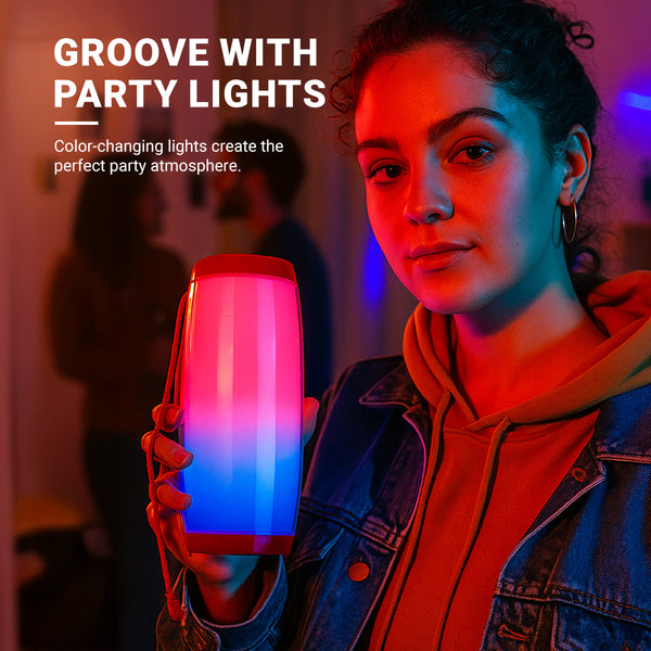 A person holds the Kleva® Glow Beats Speaker by Kleva Range, featuring red and blue color-changing lights. GROOVE WITH PARTY LIGHTS: Enjoy crystal-clear sound and vibrant lights for the ultimate party vibe.