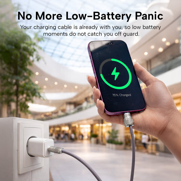 A hand holds a smartphone at 75% charge, connected to the KLEVA® Charge & Go Lanyard by Kleva Range in a modern mall. Text: Power up anywhere—stay connected with this wearable charging cable for iPhone, Android & USB-C devices.