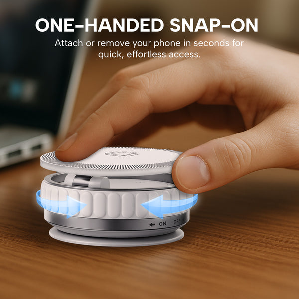 A hand attaches the KLEVA® Charge Grip 360 by Kleva Range—a MagSafe-compatible suction phone mount and wireless charging stand—to its base on a wooden surface. Blue arrows highlight easy one-handed snap-on/off for quick phone access, with a laptop in the background.