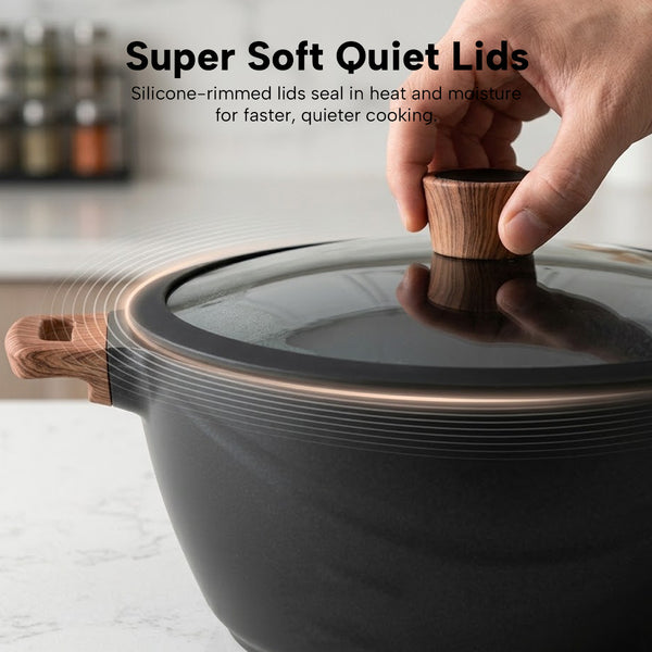 Glass lid with silicone rim on cookware pot for quiet, sealed cooking and moisture retention