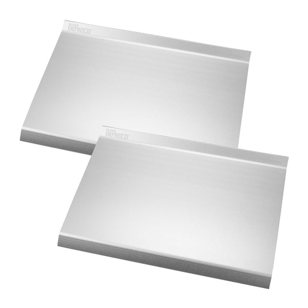 Two Kleva Range Defreezi® Defrosting Trays overlap on a white background. These stainless steel trays thaw meat and frozen food up to 5x faster without chemicals, with raised edges and engraved top left corner labels.