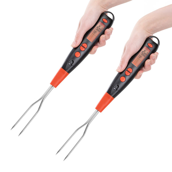 Two hands hold the KLEVA Flavour Fork™ Digital BBQ Fork by Kleva Range, featuring a black and orange handle, metal prongs, display screen showing temperature, and buttons—all visible against a plain white background.