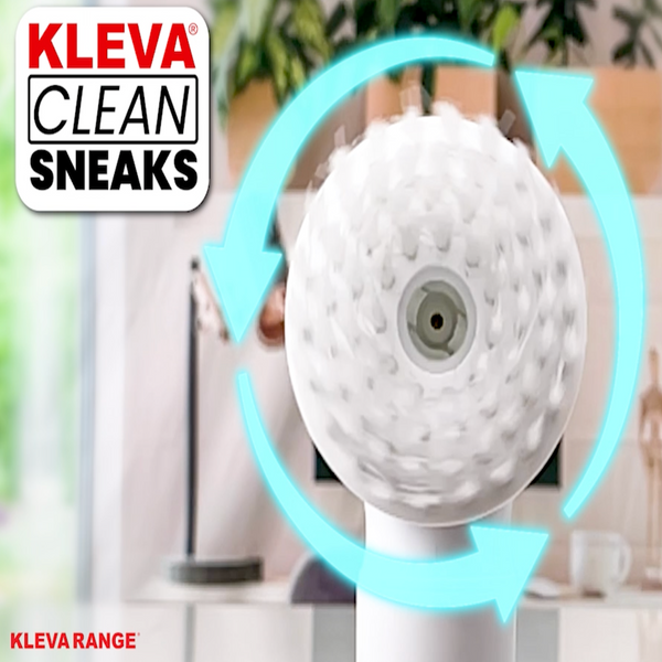 A white circular shoe cleaner with textured bristles from Kleva Range spins, shown with blue arrows and the "Make old shoes look new! Kleva Clean Sneaks Automatic Shoe Cleaner" logo on a blurred indoor background, highlighting this portable cleaner.