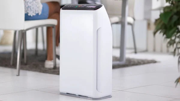 Kleva Remedical Air Purifier with HEPA filtration system positioned in a modern white living room.