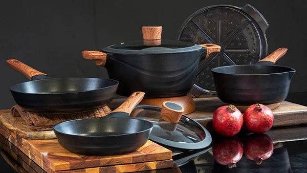Comprehensive Kleva Diamond Earth Cookware set featuring non-stick pots and pans with ergonomic wood-look handles and tempered glass lids.