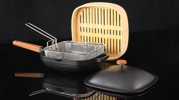 Kleva Diamond Earth Fusion square pan set including a deep non-stick pan, stainless steel frying basket, and a wooden steamer attachment.