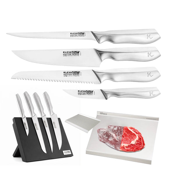 Four Japanese Vamolcrium stainless steel kitchen knives from the KlevaCut® Master Series TV Exclusive 4pc Knife Set by Kleva Range, each with labeled blades, are displayed above a sleek black magnetic block that holds the same knives. Also featured is a white defrosting tray with a piece of raw meat and a set of clear knife covers.
