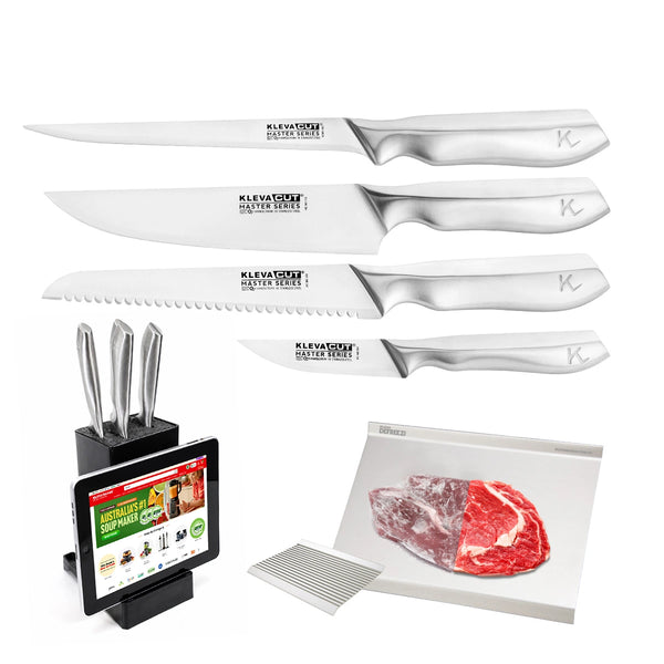 Four stainless steel knives from the Kleva Range KlevaCut® Master Series TV Special 4pc Knife Set with Knife Block & Defrosting Tray, a sleek universal knife block featuring a tablet stand, a set of metal skewers, a chopping mat, and a piece of raw steak are displayed on a white background.