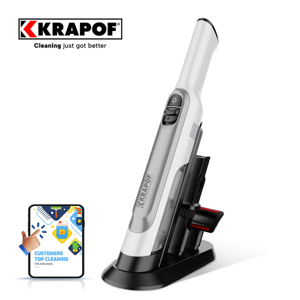 A KRAPOF® Portable Mini Plus Handy Cordless Car Vacuum Cleaner by Kleva Range stands upright on a charging stand. Next to it, a badge shows cleaning icons with the words: CUSTOMERS TOP CLEANING, TIPS AND MORE.