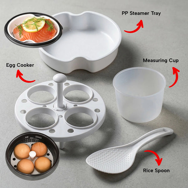 Set of kitchen utensils including an egg cooker, PP steamer tray, measuring cup, and rice spoon on a gray surface.