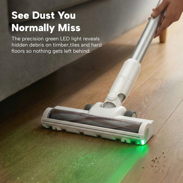 Cordless stick vacuum with green LED light revealing hidden dust under furniture