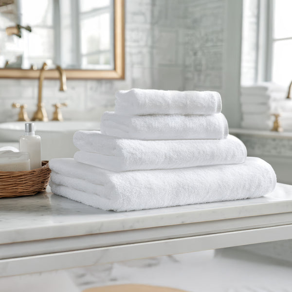 Super Sleeper Pro Premium Bath Towel pile on a marble table in a stylish bathroom