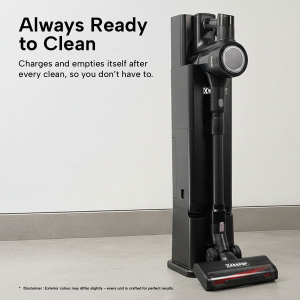 Black handheld vacuum cleaner with charging stand on a light wooden floor.