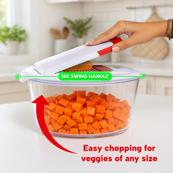 A hand presses down on the Kleva® Spin, Slice & Dice by Kleva Range, a white and red kitchen chopper with an easy 180° swing handle, shown chopping carrots. Text reads: “Easy chopping for veggies of any size.” Kitchen background visible.