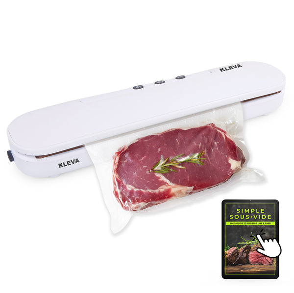 A white Kleva® Vac Seal & Save Food Saver Vacuum Sealer from Kleva Range seals a clear bag with steak and rosemary, showing how it keeps food fresh. The booklet "Simple Sous-Vide: Your Guide to Cooking Like a Chef" is next to the sealer.