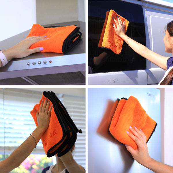 A person uses the Kleva Range The World's Best Cleaning Cloth, an orange and black reusable microfibre cloth, folded to clean a stove hood, vehicle window, glass pane, and refrigerator for eco-friendly cleaning.