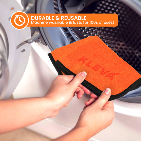 A person puts The World's Best Cleaning Cloth by Kleva Range into a washing machine. Text above states: DURABLE & REUSABLE. Machine washable & lasts for hundreds of uses!.