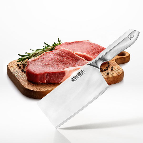 Two raw beef steaks with rosemary and peppercorns lie on a wooden board. The Kleva Range KlevaCut® Master Series Professional Cleaver Knife - 18cm, featuring a shiny Japanese steel blade and metal handle, is prominently displayed in the foreground.