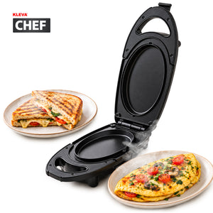 A sleek black KLEVA® Clever Chef Double-Sided Compact Grill from Kleva Range with non-stick cooking plates sits open next to a plate holding a grilled sandwich and another plate with an omelette topped with tomatoes and herbs. The Kleva Range logo appears in the top left corner.
