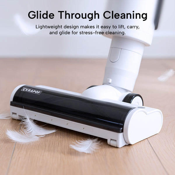The KRAPOF® Compact Clean Self-Empty Cordless 2-in-1 Handy Vacuum Cleaner by Kleva Range glides over wooden floors, picking up debris with ease. Text above reads Glide Through Cleaning, emphasizing its lightweight, easy-to-carry design for stress-free use.