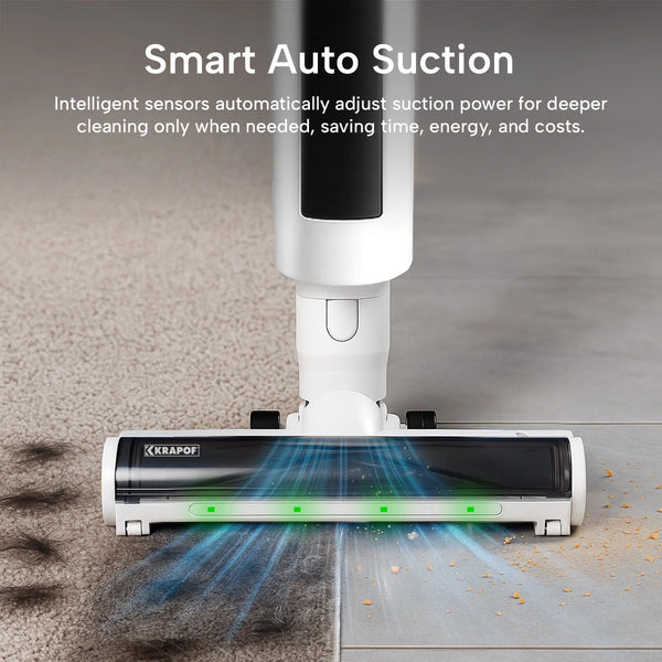 A cordless stick vacuum cleaner shown from above, cleaning a beige carpet and a gray floor. The vacuum has a white and black body with a transparent floor head showing suction airflow.