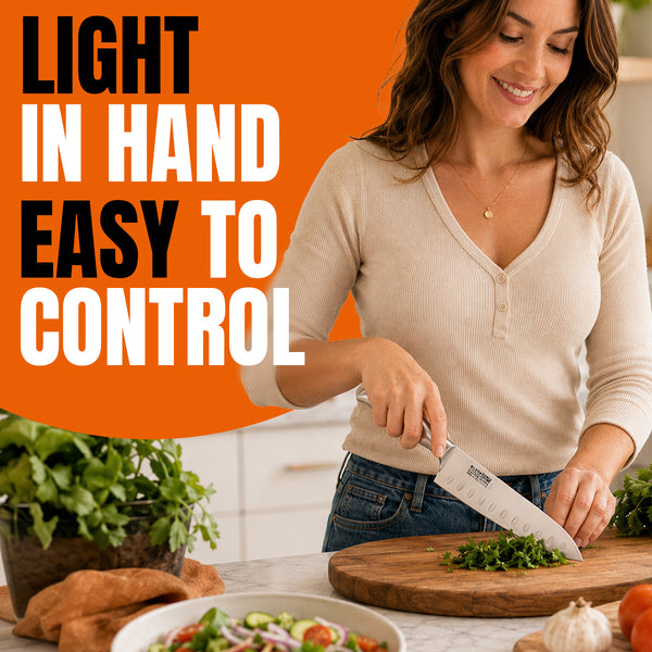 A woman chops herbs on a wooden cutting board with a chef’s knife from the Kleva Range KlevaCut® Master Series 4pc Knife Set with Bamboo Storage Case in her kitchen. Orange and white text on the left reads, Light in hand, easy to control. Fresh vegetables and herbs are arranged on the counter nearby.