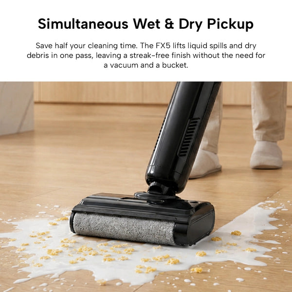 The KRAPOF® FX5 HydraClean Cordless Hard Floor Washer by Kleva Range is shown vacuuming dry debris and cleaning a liquid spill on hard floors. Its dual-tank mop system allows for simultaneous washing and vacuuming. A pair of feet is visible in the background.