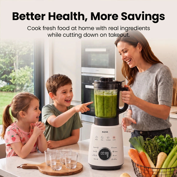 A woman uses the Kleva Range Mealio® Hot & Cold Blender—Professional Soup Maker & Smoothie Blender in 1—to prepare a green smoothie for two children in the kitchen, surrounded by fresh vegetables and water, enjoying a healthy moment together.