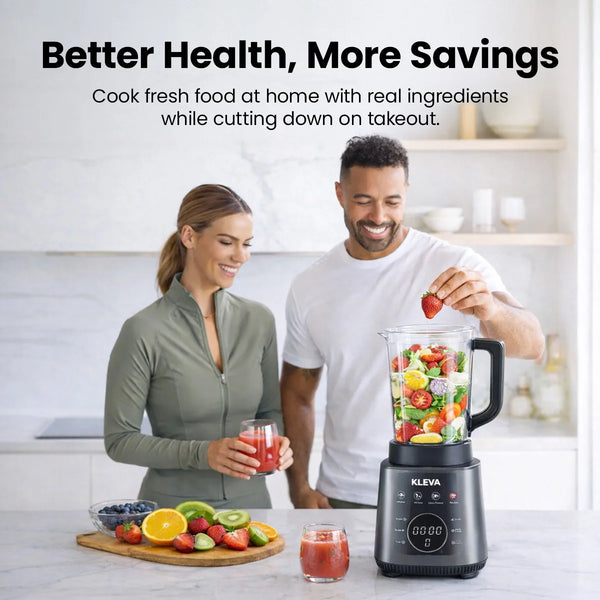 A happy couple using the Kleva Mealio to prepare fresh, healthy smoothies with real fruit in a modern kitchen setting.