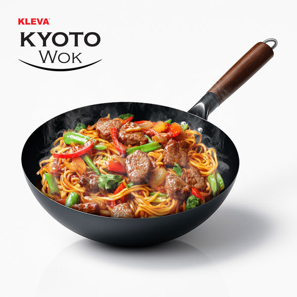 A black KLEVA® Kyoto Wok 28cm from Kleva Range, featuring a wooden handle and natural non-stick surface, holds steaming stir-fried noodles, vegetables, and meat. The text "Kleva All Natural Wonder Wok" is shown in the top left corner.