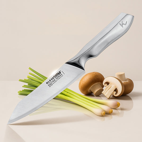 The Kleva Range KlevaCut® Master Series Professional Oriental Cooks Knife – 18cm rests on a beige surface, its blade on lemongrass stalks, with neatly arranged sliced and whole white mushrooms nearby.