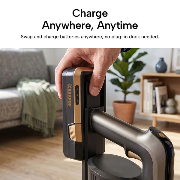 A hand swaps the battery on the KRAPOF® S3 Power Vac Cordless Stick Vacuum by Kleva Range in a living room with a sofa, blanket, and plant. Text highlights easy battery charging—no dock needed. Ideal for fast pet hair cleanup. Includes extra FREE second battery.
