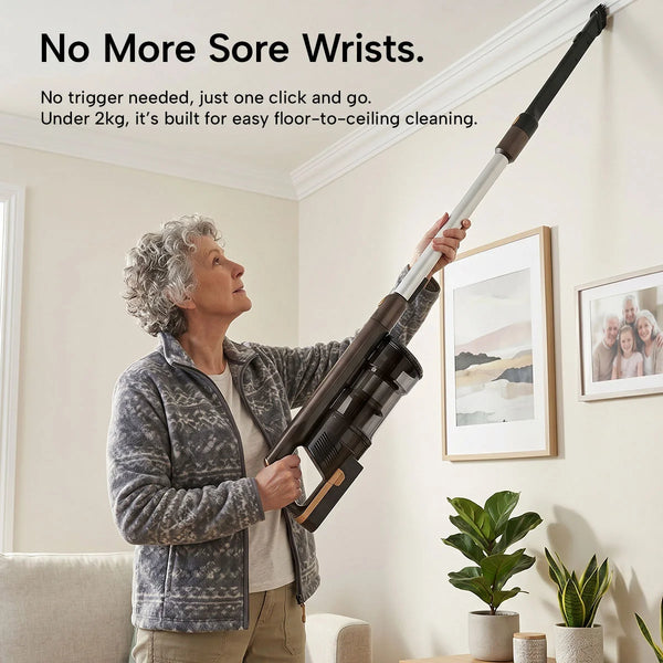 An older woman uses the KRAPOF® S3 Power Vac Cordless Stick Vacuum by Kleva Range, featuring an extended handle, to effortlessly clean pet hair from floor to ceiling. The text highlights its light weight and ease of use. Includes a FREE extra battery.