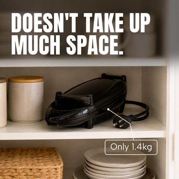 A black KLEVA Quick Grill by Kleva Range with a cord sits on a white shelf next to three canisters, with text above reading DOESN’T TAKE UP MUCH SPACE and a label indicating its weight as Only 1.4kg. Featuring non-stick plates, this compact appliance makes cleaning up after cooking effortless.