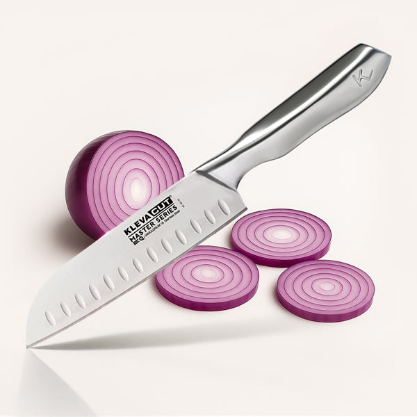 A KlevaCut® Master Series Professional Santoku Knife - 18cm from Kleva Range lies beside a halved red onion and three slices on a light surface, featuring precision Japanese steel for effortless slicing.