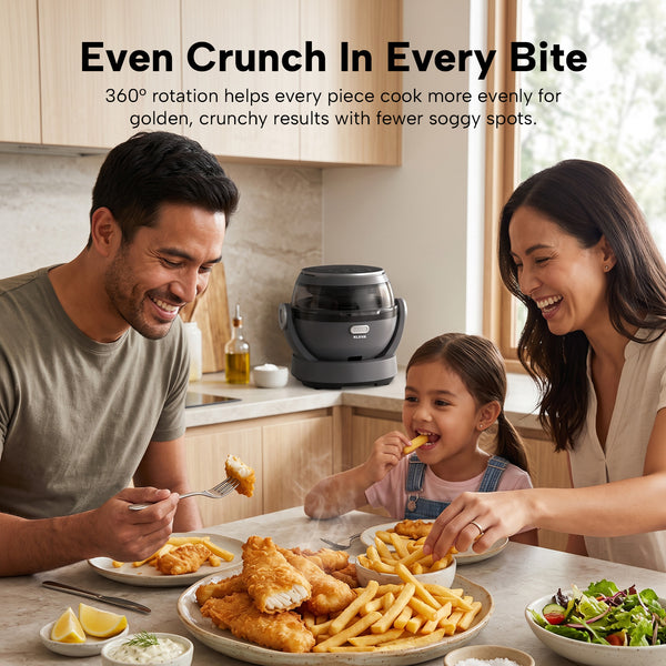 A man, woman, and young girl sit at a kitchen table eating fried fish and fries. On the countertop is the Kleva® Spin Crisp IQ Rotating Digital Air Fryer from Kleva Range, featuring 360° auto-rotate technology for even cooking.