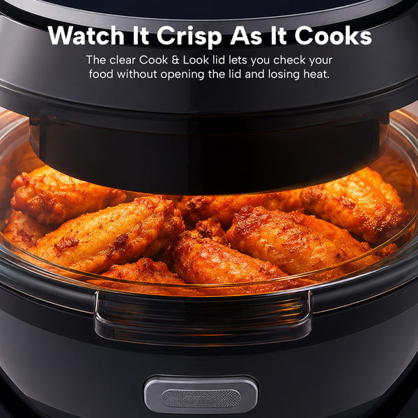 A close-up of the Kleva® Spin Crisp IQ Rotating Digital Air Fryer by Kleva Range shows crispy chicken wings cooking inside. Its transparent lid and 360° auto-rotate tech let you watch your food cooking to perfection.