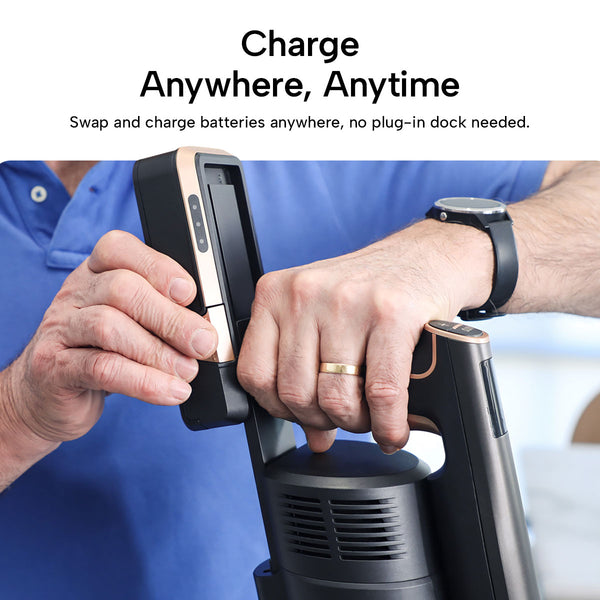 A person removes a rectangular battery from the KRAPOF® Super Slim Power Vac Cordless Stick Vacuum by Kleva Range. Text above reads, "Charge anywhere, anytime—swap and recharge batteries without a dock.