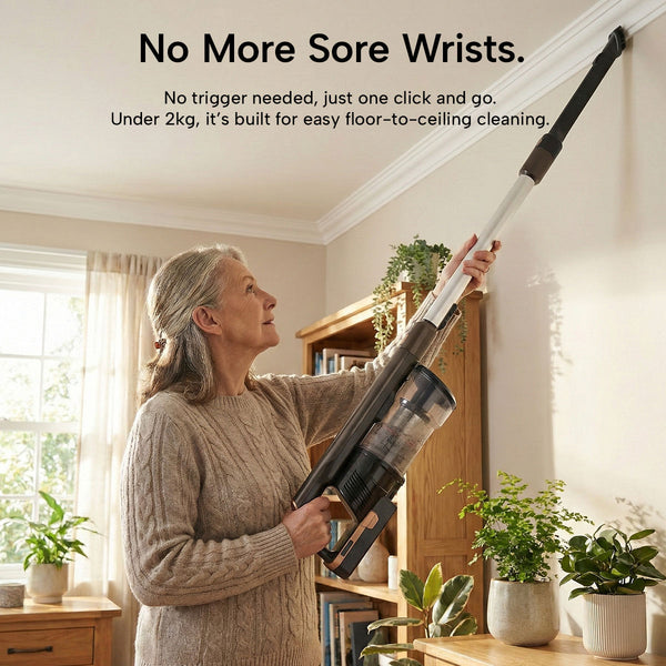 A woman easily cleans near the ceiling in a bright living room using the KRAPOF® Super Slim Power Vac Cordless Stick Vacuum from Kleva Range, featuring ultra-lightweight design, powerful suction, and an extra FREE second battery. Text above highlights easy handling.