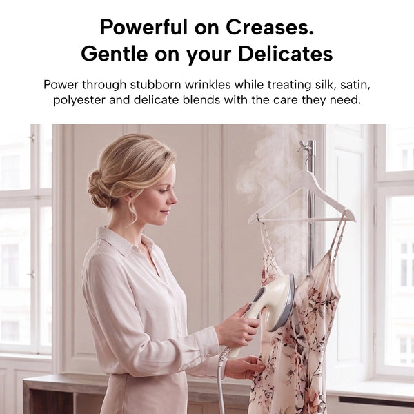 In a bright room, a woman uses the KLEVA® Crease Boss Steam Iron by Kleva Range on a floral dress hanging on a rack. Text above highlights the Crease Boss as highly effective on stubborn creases and gentle on delicate fabrics, making it an ideal wrinkle remover for every wardrobe.