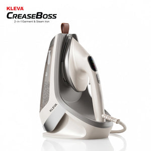 A white and gray KLEVA® Crease Boss Steam Iron by Kleva Range, designed as a powerful wrinkle remover, is shown standing upright on its charging base against a plain white background. The brand name appears on both the iron and the base.
