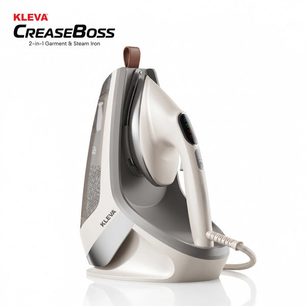 A white and gray KLEVA® Crease Boss Steam Iron by Kleva Range, designed as a powerful wrinkle remover, is shown standing upright on its charging base against a plain white background. The brand name appears on both the iron and the base.